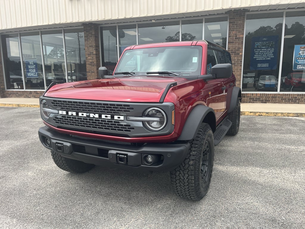 2026 Ford Bronco Badlands in Ruby Red Metallic Tinted Clearcoat — front three-quarter view
