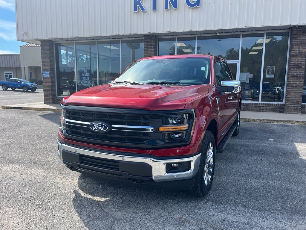 2026 Ford F-150 XLT in Ruby Red Metallic Tinted Clearcoat — front three-quarter view
